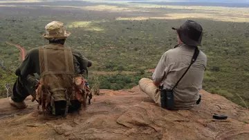 Chris and security ranger looking out over Tsavo