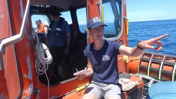 A ZSL conservationist on a boat to test underwater detection equipment