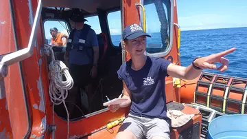 A ZSL conservationist on a boat to test underwater detection equipment