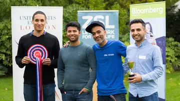 The four members of team ODINN pose for a photo with their rosette and trophy