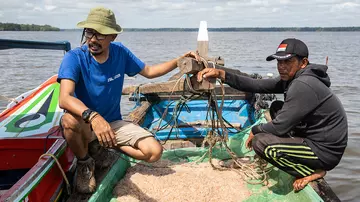 conservationists in Indonesia in boat