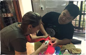 Sophie working with the staff at the Save Vietnam's Wildlife Centre to help an injured pangolin