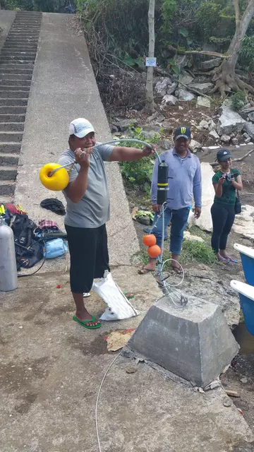 A man throwing a bouy into the river