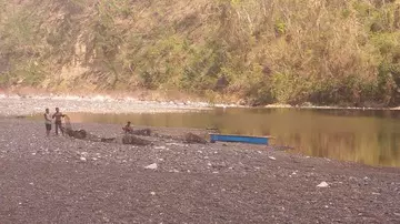 Drying fyke nets after eel surveys at Duba fish sanctuary on the river bank