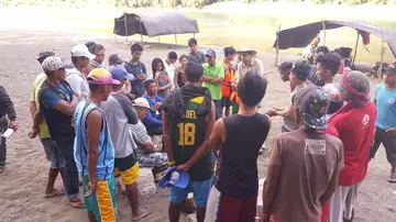 A group of people talking to local communities