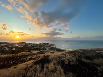 Ascension Island with a sunset and clouds in the sky