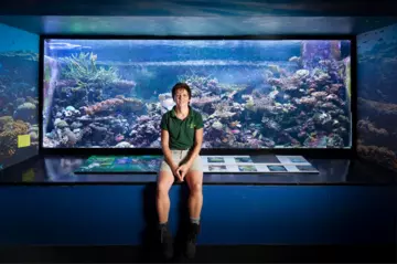 Rachel in front of an aquarium tank