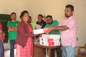 Distributing cooking stoves in Kusum village