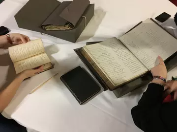 Visitors consulting papers in our archives