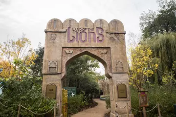 The Land of the Lions archway surrounded by greenery