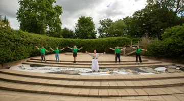 Artist Linder with ZSL team at unveiling of Sirona standing by the mosaic with their arms out