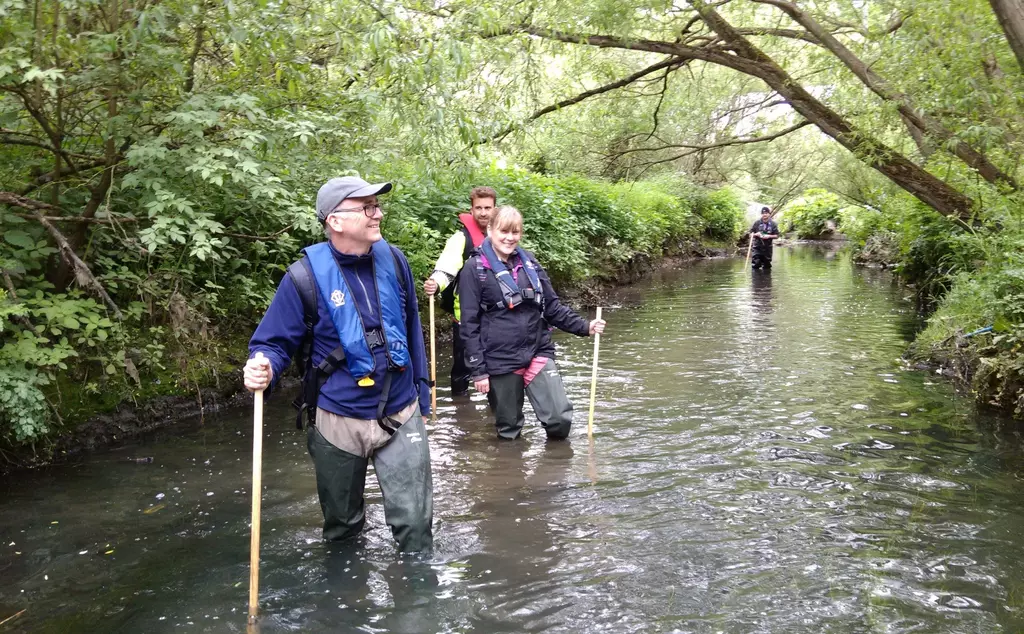 A group of citizen scientist volunteers in a river
