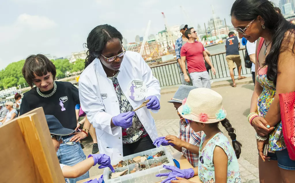 soapbox science display london with two young girls interacting with installation 