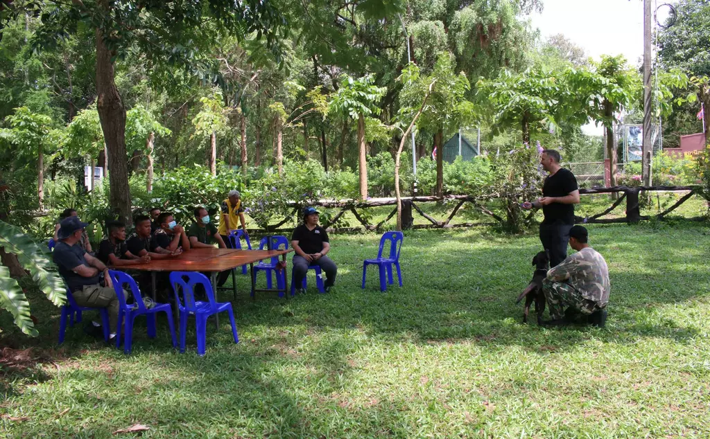 A group of people sitting around a table at a capacity building workshop for the DNP detection dog unit in Chonburi, Thailand, coordinated by ZSL with support from Lee Fairman, NPCC Dog Instructor and Dog Legislation Officer, and Grant Miller, ZSL’s Counter Trafficking Advisor.  