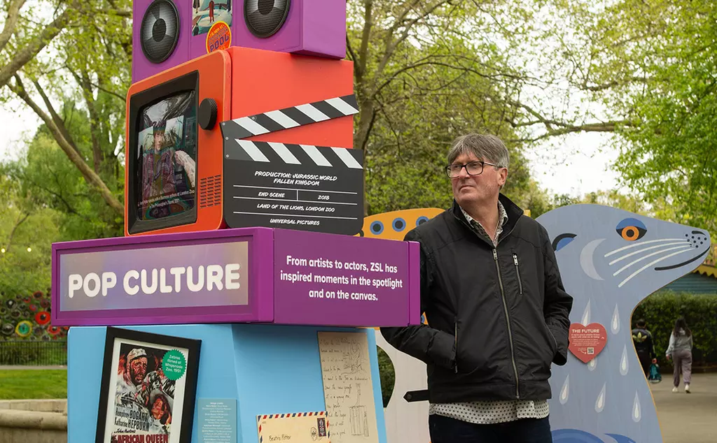 Poet Laureate Simon Armitage standing by the Pop Culture section of the 200 Exhibition