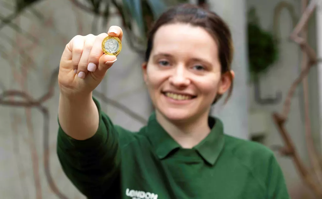 Keeper hold a commemorative £2 coin