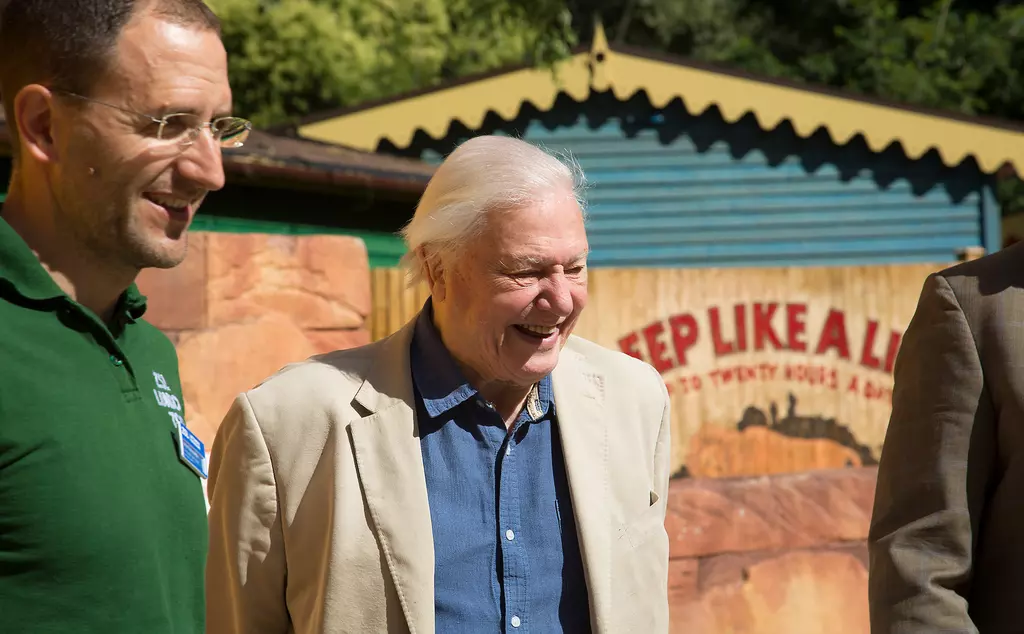 Sir David Attenborough and a zookeeper standing by Land of the Lions at London Zoo