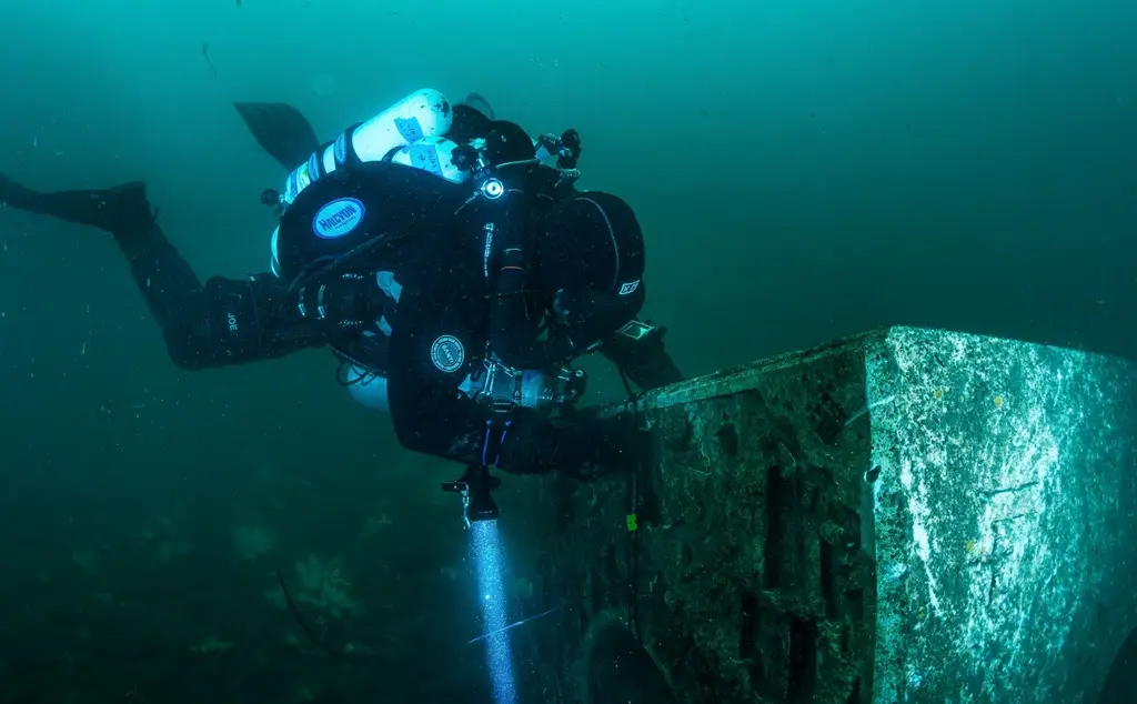 Diver completing survey of oyster reef cube