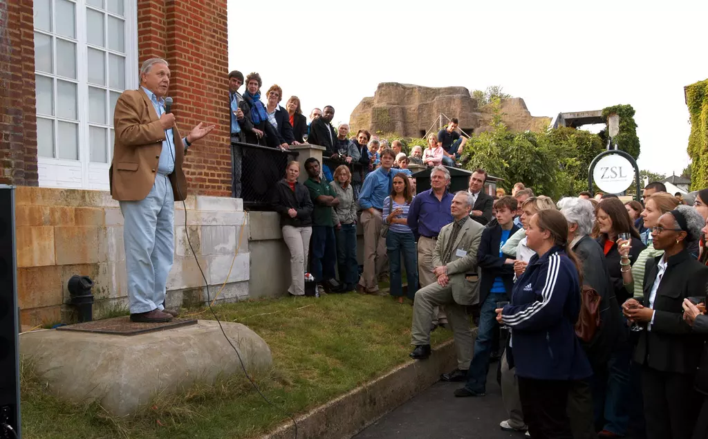 Sir David Attenborough with a microphone speaking to a crowd at London Zoo