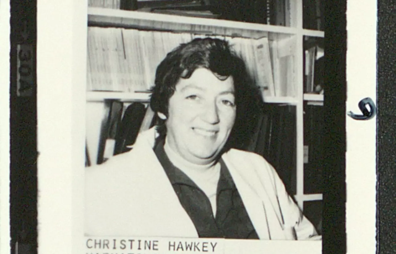 A black and white photograph of a female scientist