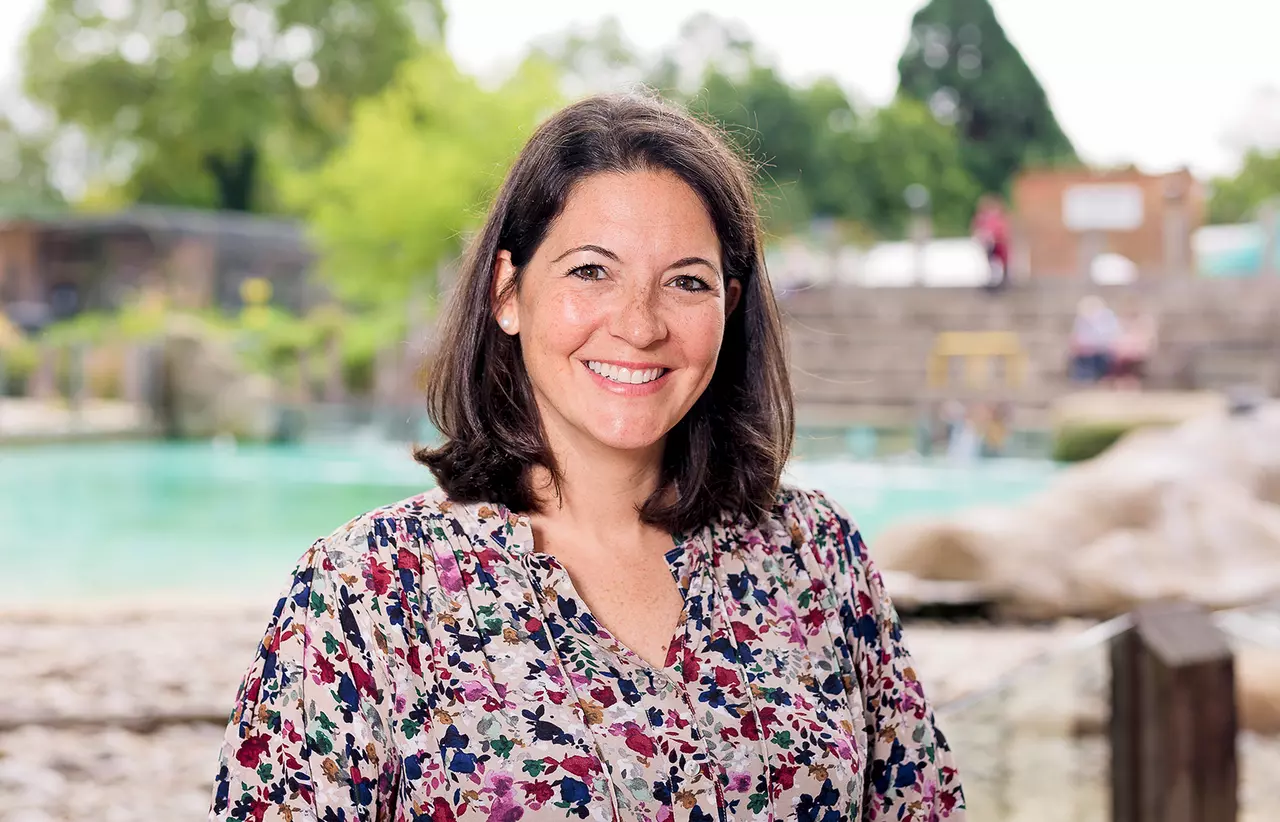 ZSL CEO Kathryn England standing in front of Penguin Beach at London Zoo