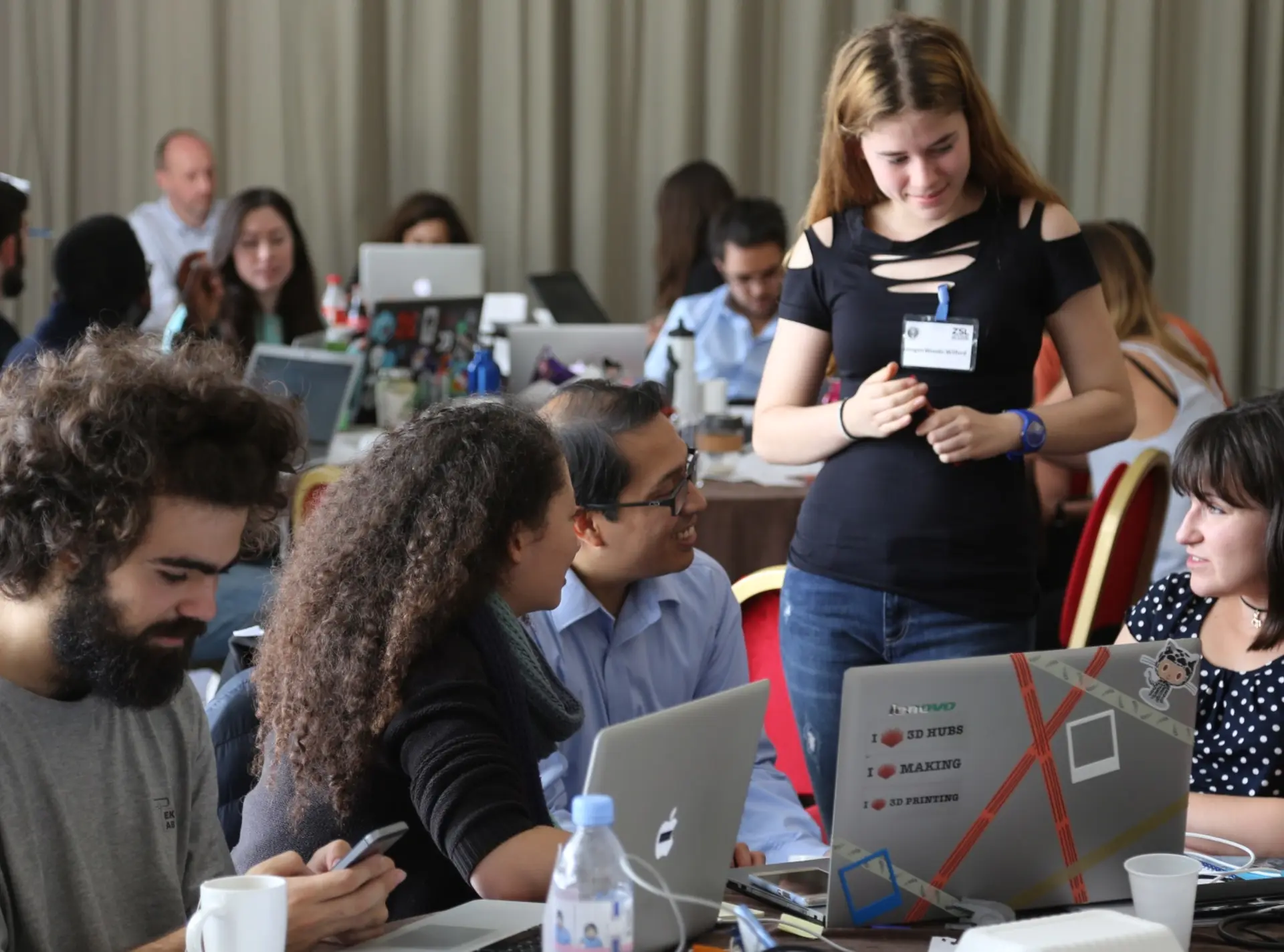 A team sit at their laptops at the Zoohackathon event
