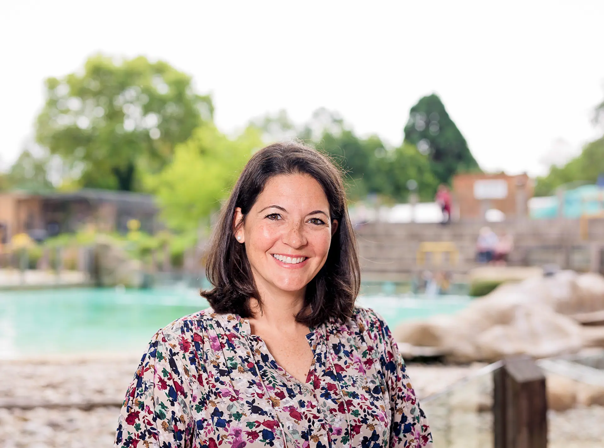 ZSL CEO Kathryn England standing in front of Penguin Beach at London Zoo