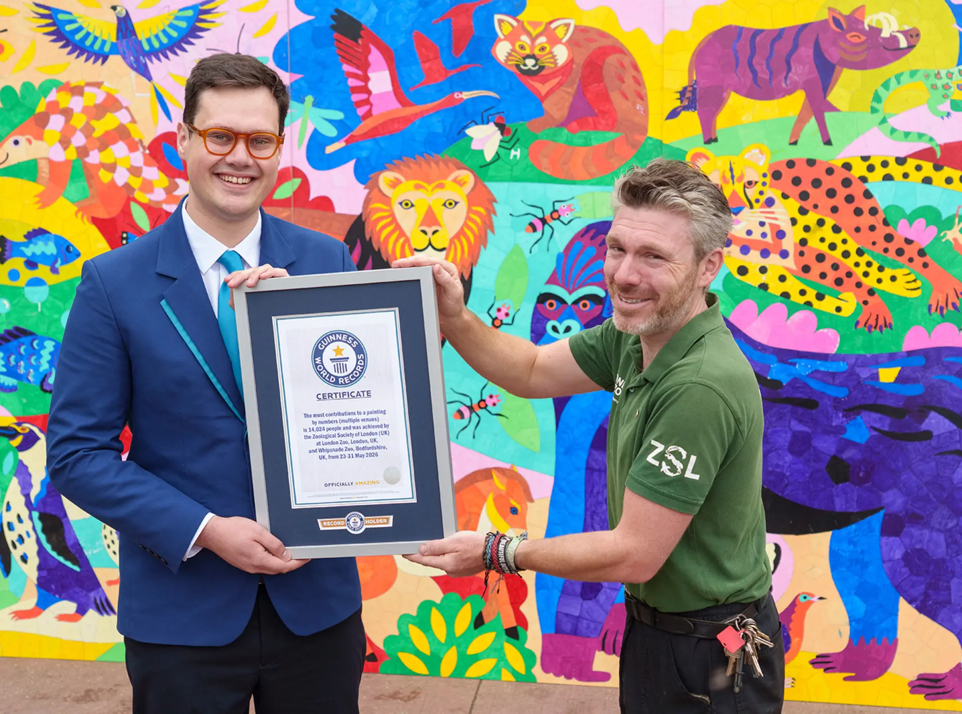 A keeper recieves the record certificate with the colour paint-by-numbers in the background