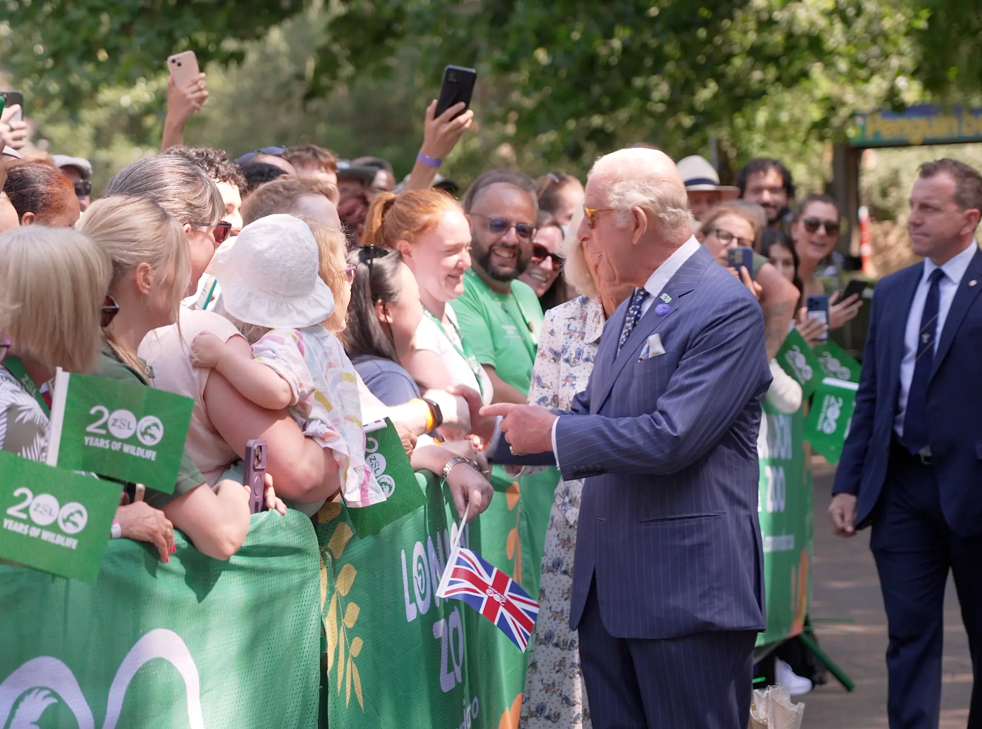 HRM King Charles meets staff and members of the public outside penguin beach