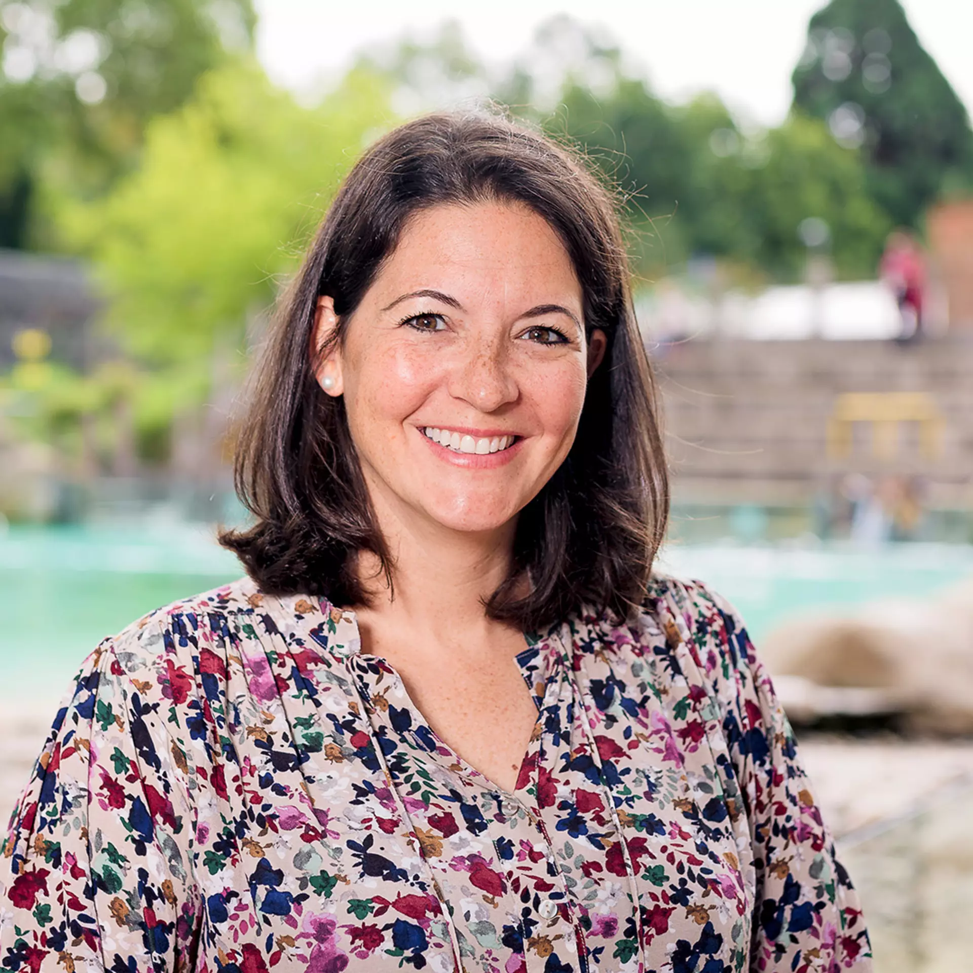 ZSL CEO Kathryn England standing in front of Penguin Beach at London Zoo