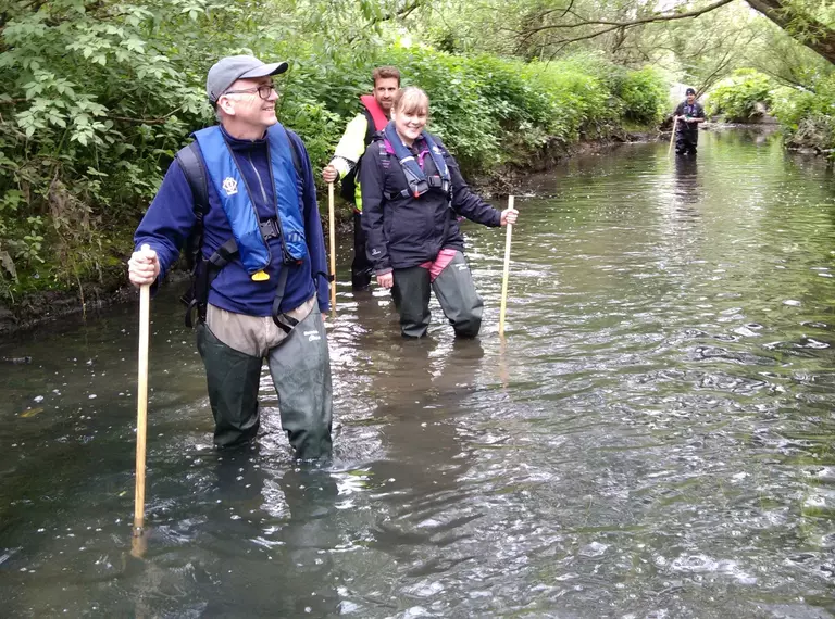 conservationists_wading_through_river