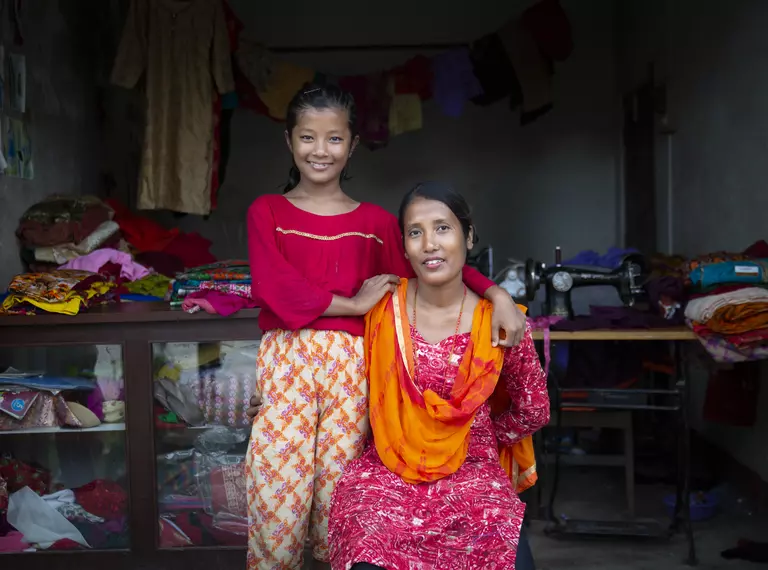 Gayatri Rai with her daughter in front of tailoring shop