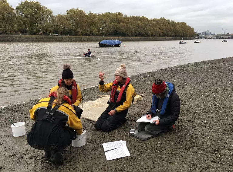 Four ZSL conservationists study fish and record results on the Putney foreshore