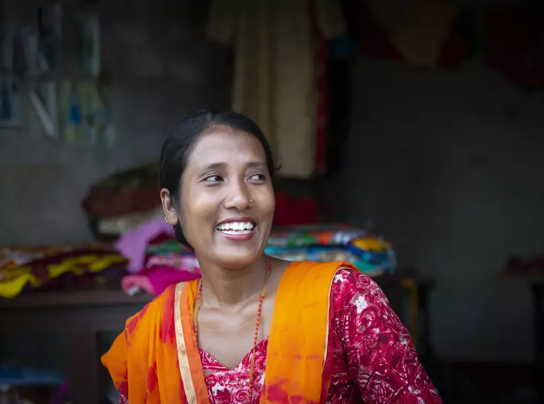 Gayatri Rai smiling in front of sewing shop ZSL supported