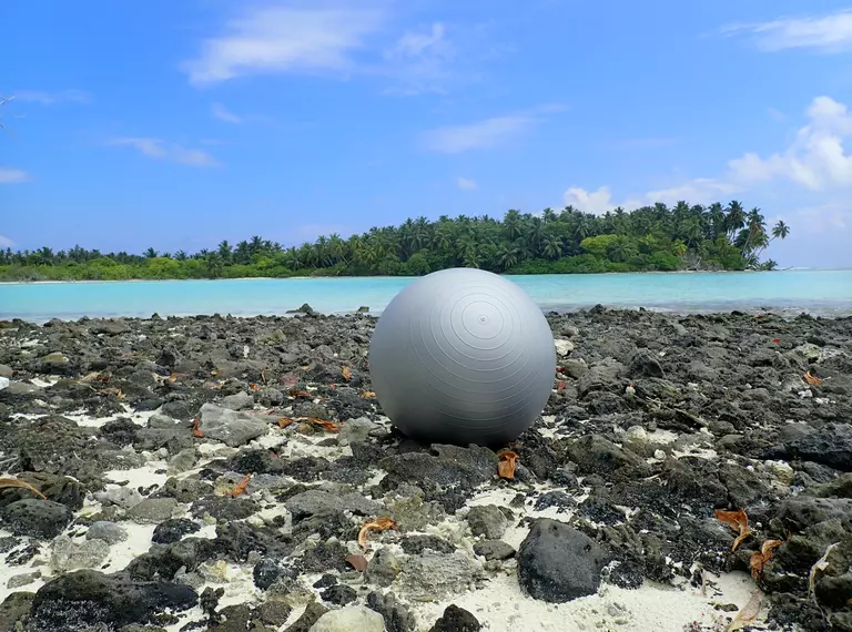 Plastic sports ball washed up on tropical shore