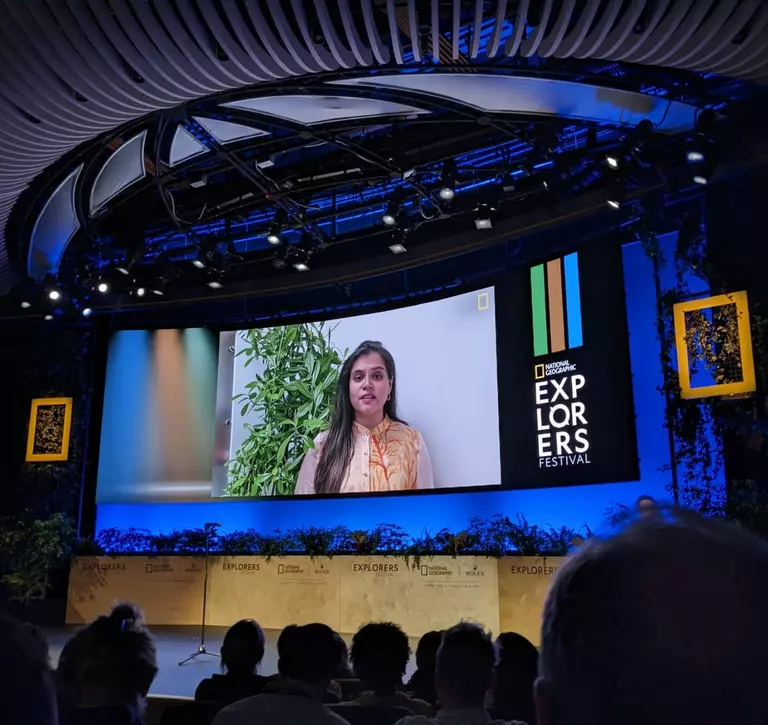 Surshti Patel speaking at on screen at National Geographic Explores Festival 