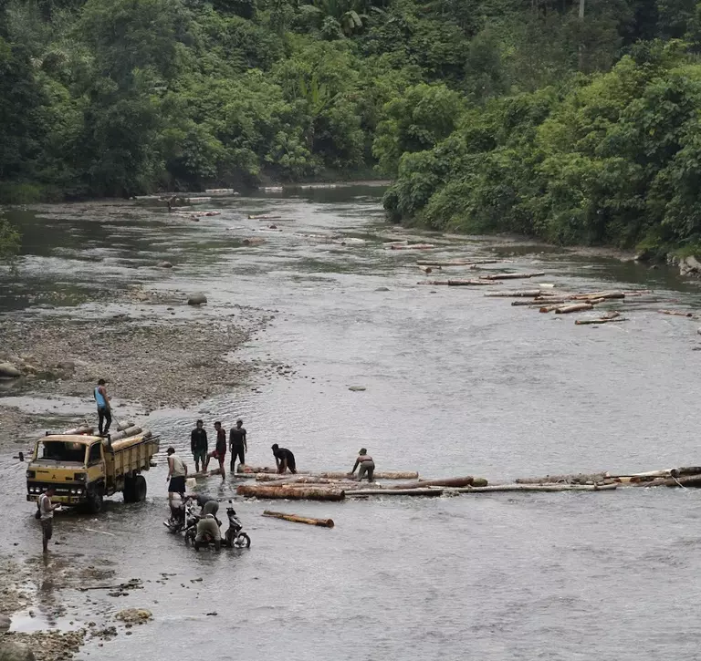 People logging on a river