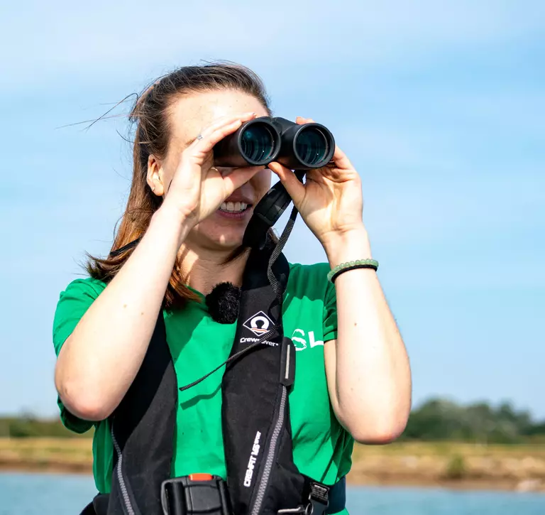 ZSL conservationist Hannah McCormick observing seals during Thames seal survey