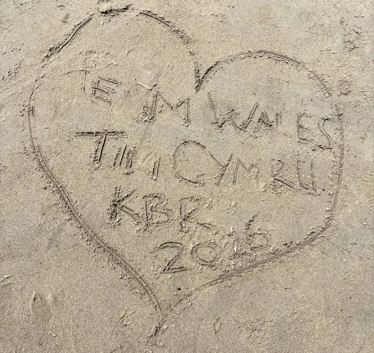 Heart in sand with writing reading Team Wales / Tim Cymru KBR 2026